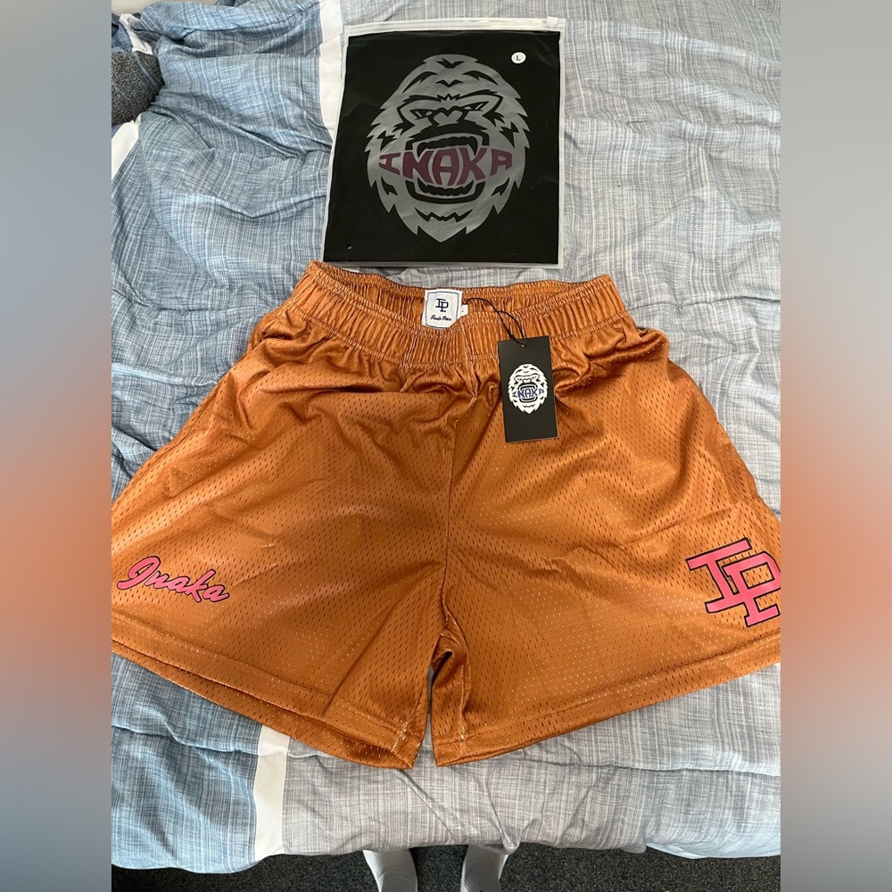 Inaka Power Men's Athletic Shorts — Rust Orange with Pink Logos